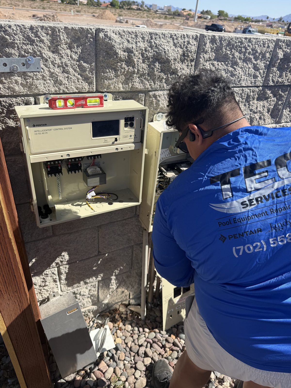 Tec Services technician servicing a Pentair IntelliCenter control panel